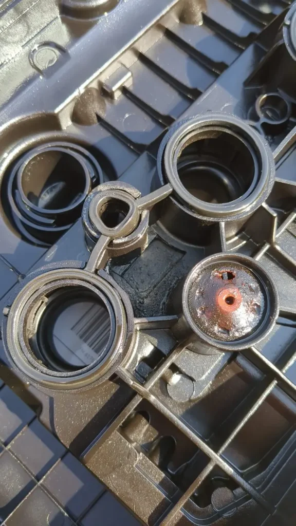 Damaged PCV valve and gasket on a rocker cover for Peugeot 5008 1.6 turbo engine 2010